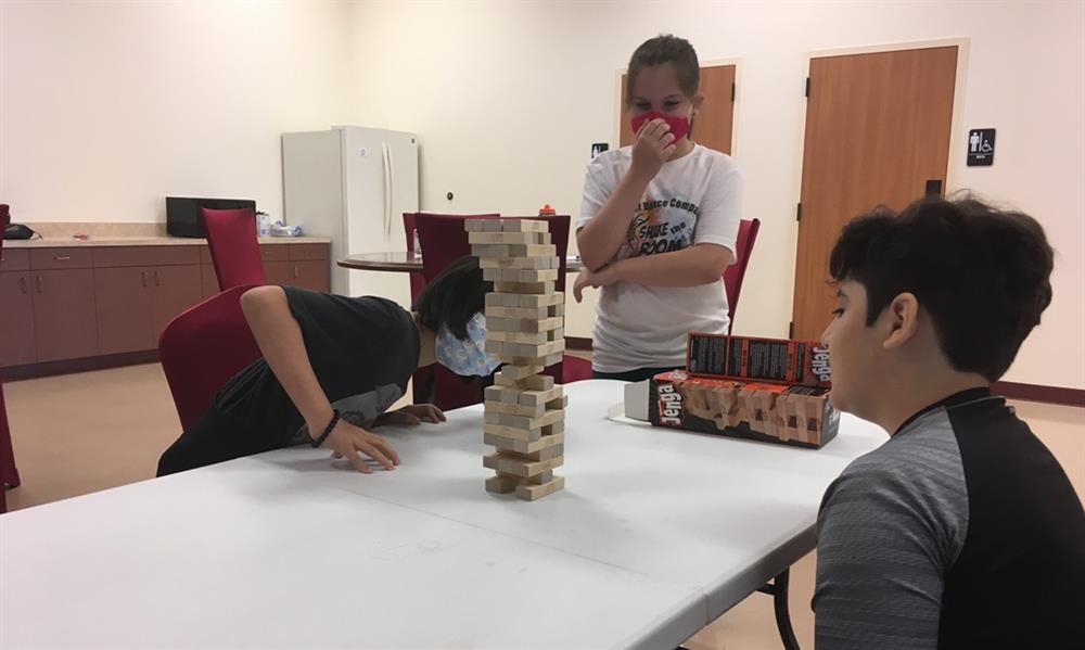 Children Summer Camp in Houston at DanceSport Club. playing Jenga game