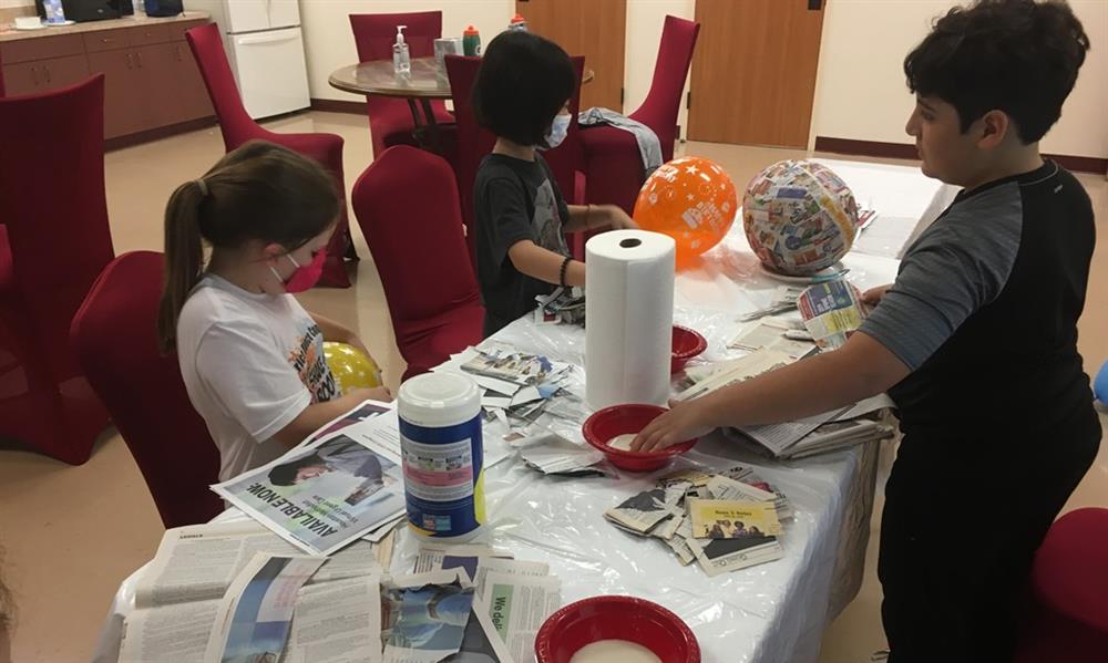 Children Summer Camp in Houston at DanceSport Club. Making pinata craft project