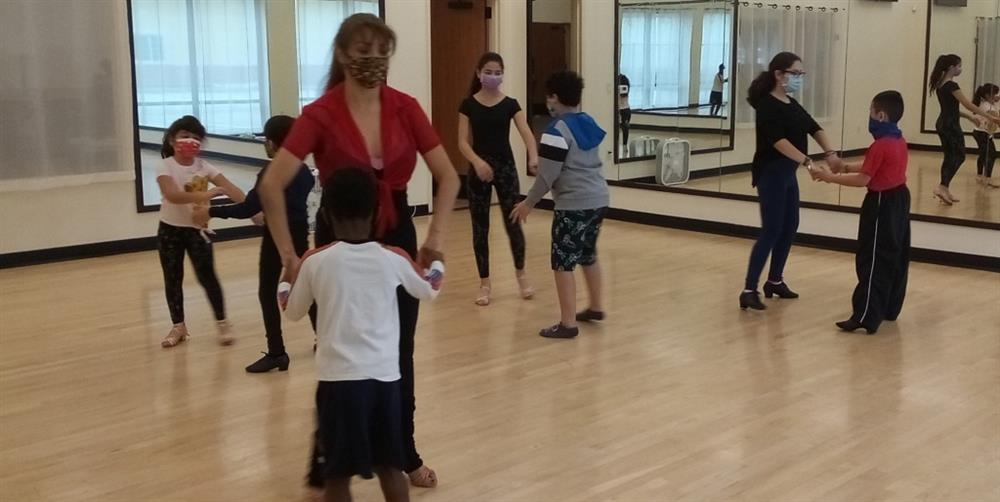 Children learn ChaCha in dance class in Houston