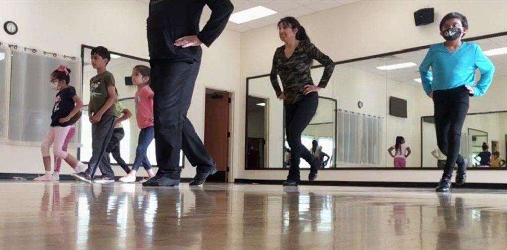 Children learn basic waltz steps in dance class